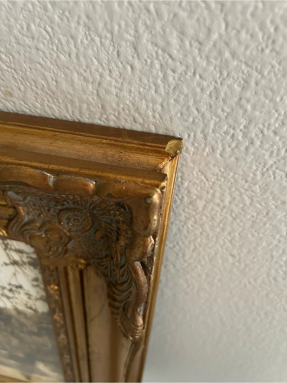 Framed art in gilded ornate frame